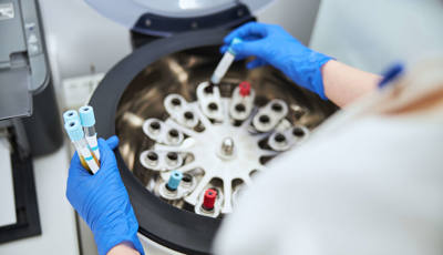 Laboratory biochemist positioning sodium citrate vacutainers for analysis and sample preservation